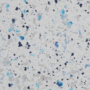 White speckled surface with blue and black flecks.