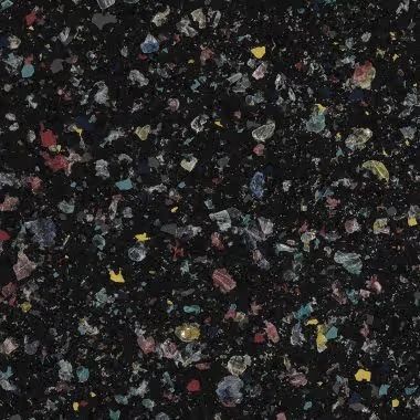 Black surface speckled with colorful chips.