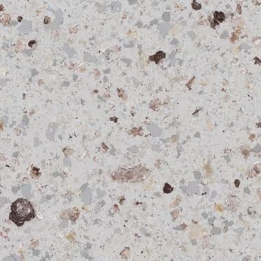 Close-up of a speckled, light gray surface with brown and tan flecks, resembling a countertop.