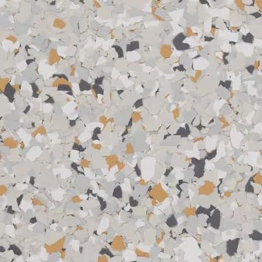 Close-up of a speckled floor. Colors include white, grey, black, and gold.