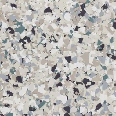 Close-up of a speckled floor coating, featuring chips of gray, beige, blue, and black.