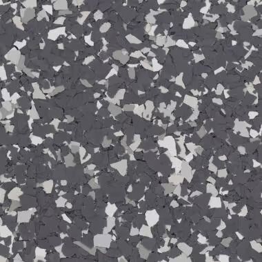 Close-up of a speckled flooring surface with gray, light gray, and white chips embedded in a darker gray base.