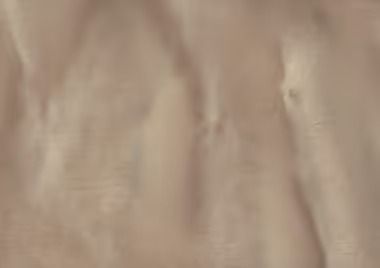 Tan fabric with flowing folds.