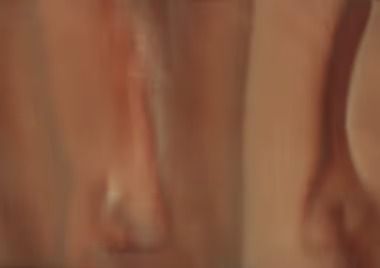 Human legs, blurred and close-up, with visible skin tones and soft focus.