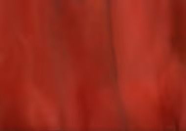 Red fabric, blurred, with vertical streaks.
