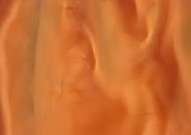 Orange and tan abstract swirls, possibly fabric or fluid, creating a soft, blurred texture.