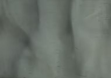 Gray, textured surface with vertical streaks.