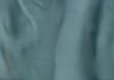 Pale blue fabric with soft folds and shadows.
