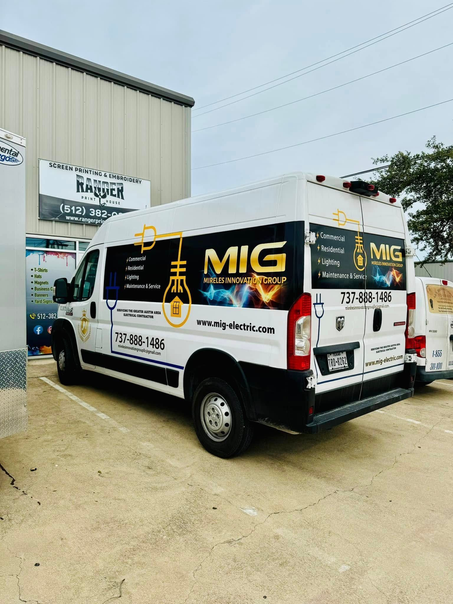 White MIG-branded service van parked outside a building on a gravel lot.
