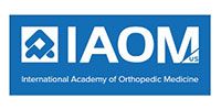 Logo for the International Academy of Orthopedic Medicine (IAOM-US) featuring blue background and white text and icon.