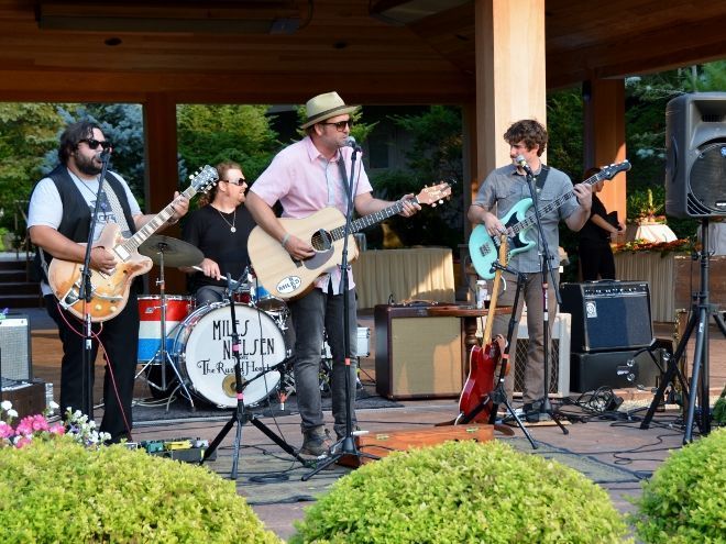 A businessman wearing a suit and tie riding in a Rockford Rides Limousine. He is traveling to Chicago Illinois for business travel.