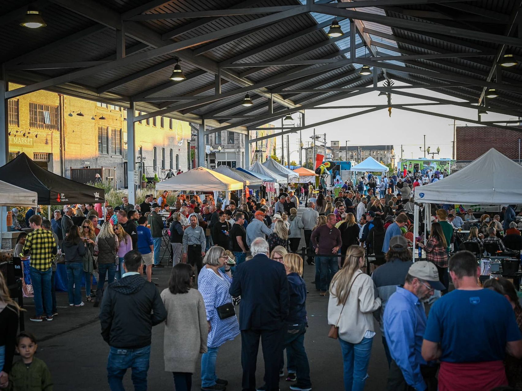 Two exuberant Chicago Bears fans are enjoying the game day atmosphere, dressed in team jerseys and sporting playful accessories like sunglasses, a headband, and fake mustaches. They embody the high spirits and camaraderie that fans can expect when traveling to a Bears game with Rockford Rides, which offers party bus services from Rockford to Chicago, ensuring fans arrive at Soldier Field ready to cheer on their team.