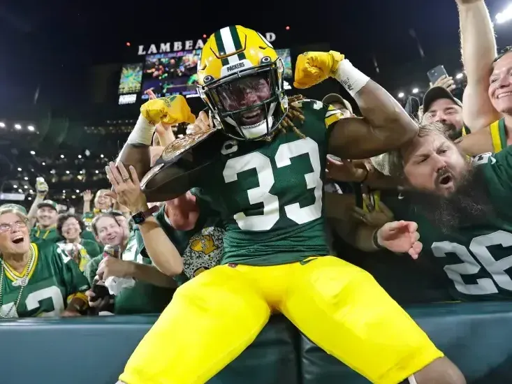 Two exuberant Chicago Bears fans are enjoying the game day atmosphere, dressed in team jerseys and sporting playful accessories like sunglasses, a headband, and fake mustaches. They embody the high spirits and camaraderie that fans can expect when traveling to a Bears game with Rockford Rides, which offers party bus services from Rockford to Chicago, ensuring fans arrive at Soldier Field ready to cheer on their team.