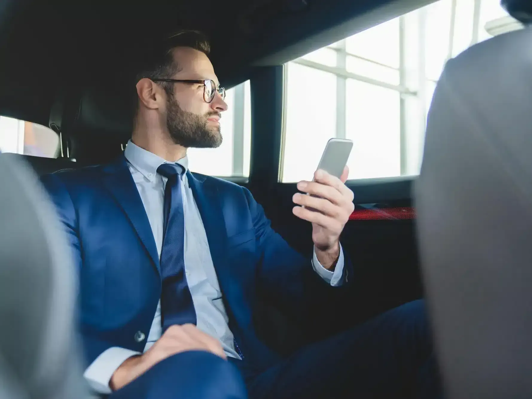 A group of five women dressed in glamorous evening attire is celebrating inside a luxurious limousine, part of Rockford Rides Limo service. They are toasting with champagne, laughing, and enjoying themselves under the vibrant neon lights of the limo's interior. This image conveys the fun and elegance of a bachelorette or birthday party, emphasizing the stylish and festive atmosphere provided by Rockford Rides for such special occasions