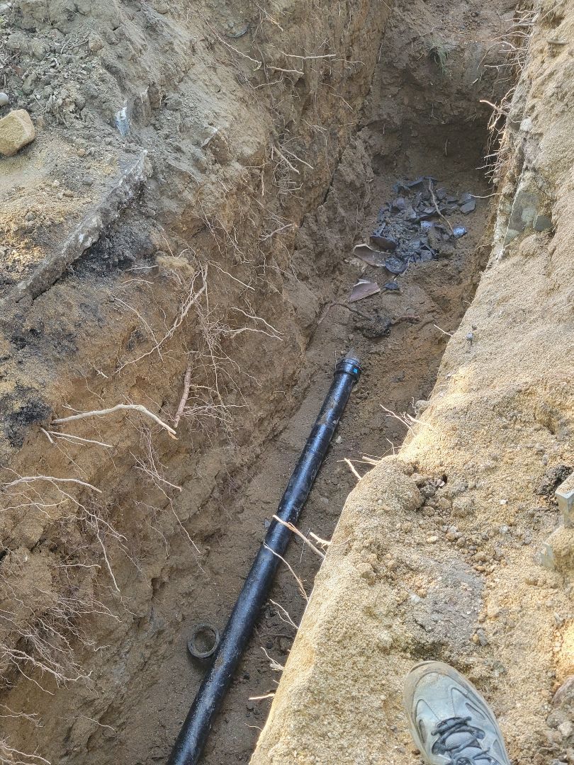 Damaged underground sewer line exposed during excavation for sewer repair and replacement in Philly.