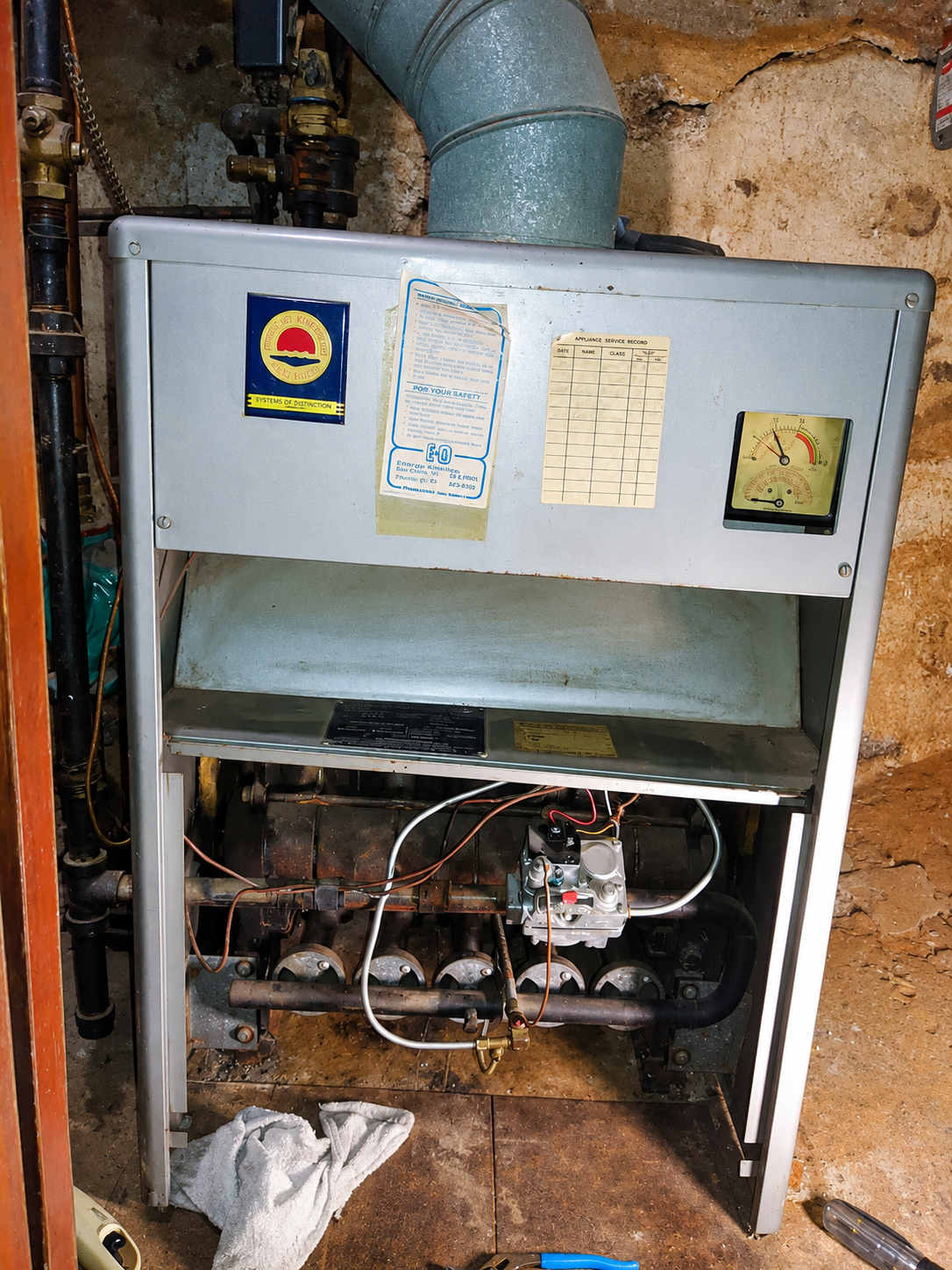 Residential boiler being serviced during annual maintenance to prepare the home for heating season.
