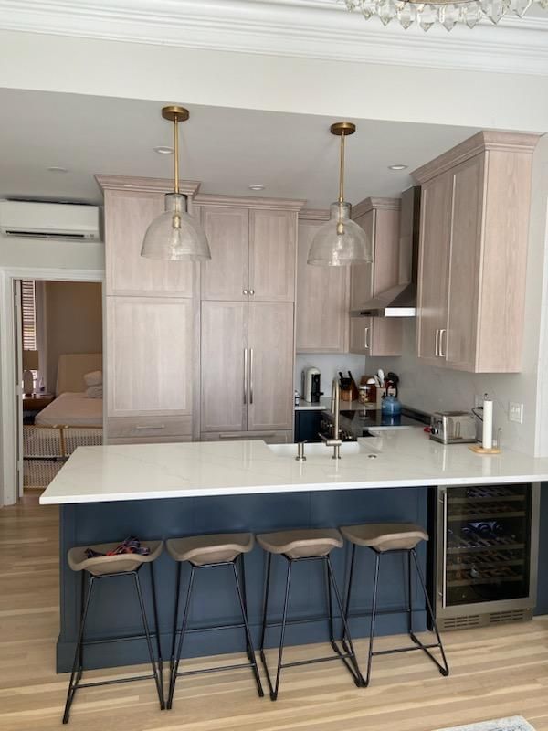 A kitchen with a large island and stools