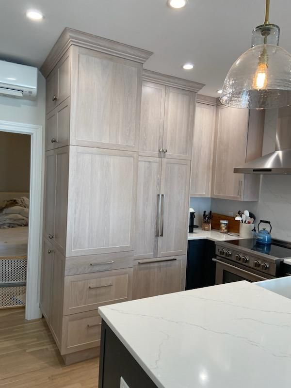 A kitchen with stainless steel appliances and wooden cabinets