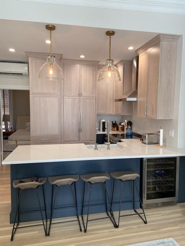 A kitchen with a large island and stools