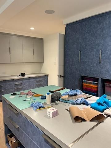 There is a table in the middle of the room with a lot of items on it.