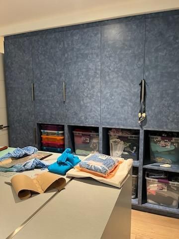 A room filled with lots of clothes and boxes.