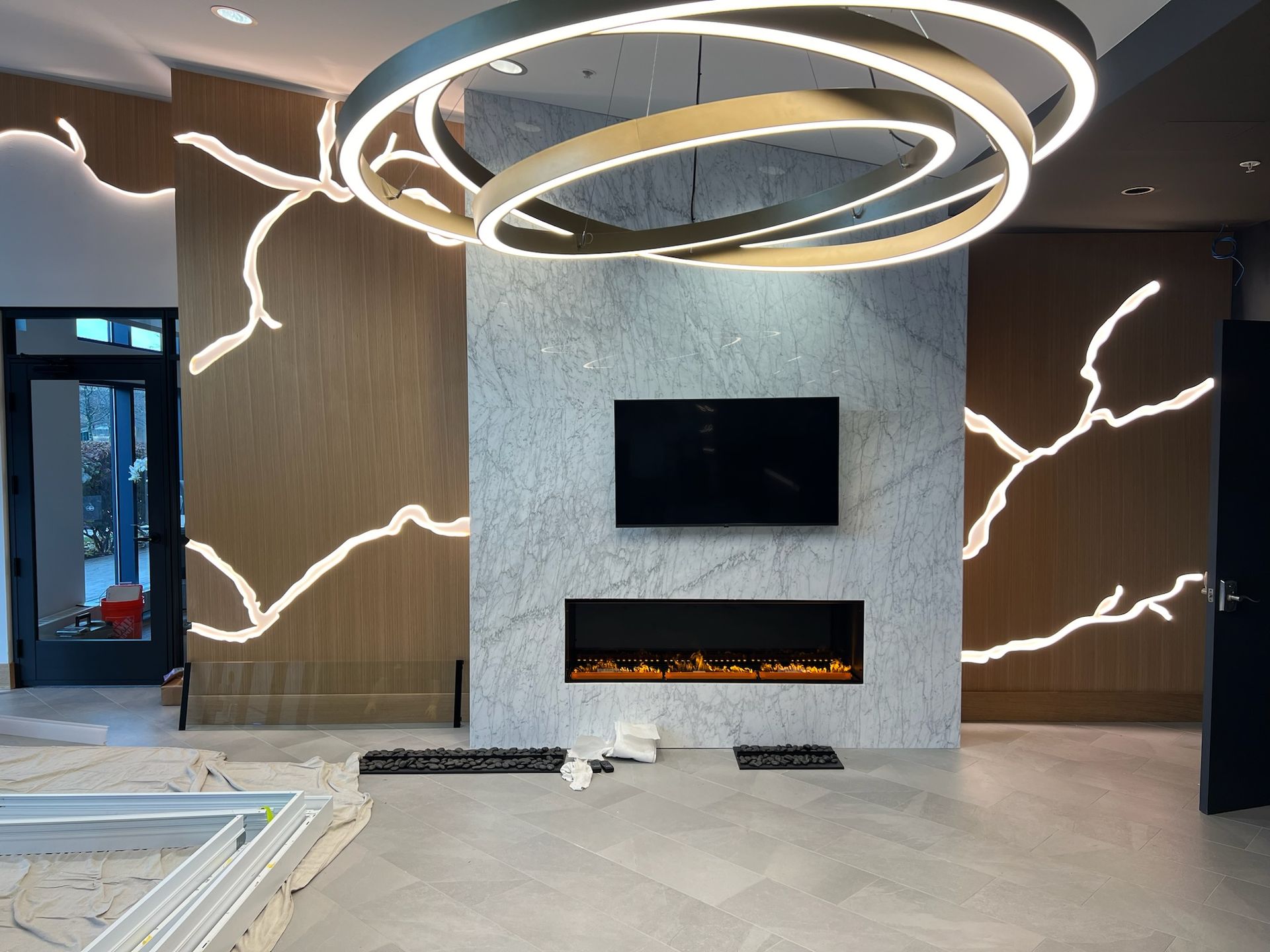 A living room with a fireplace and a flat screen tv