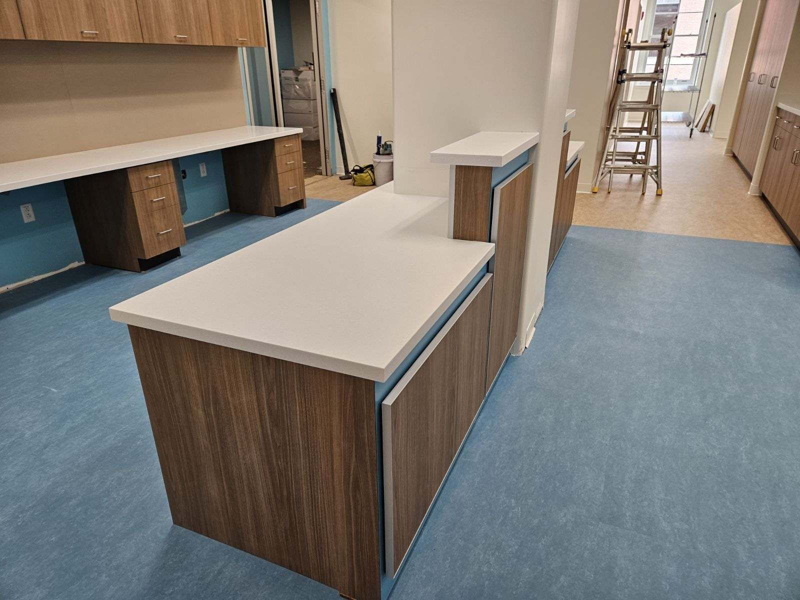 A kitchen with wooden cabinets and a white counter top.