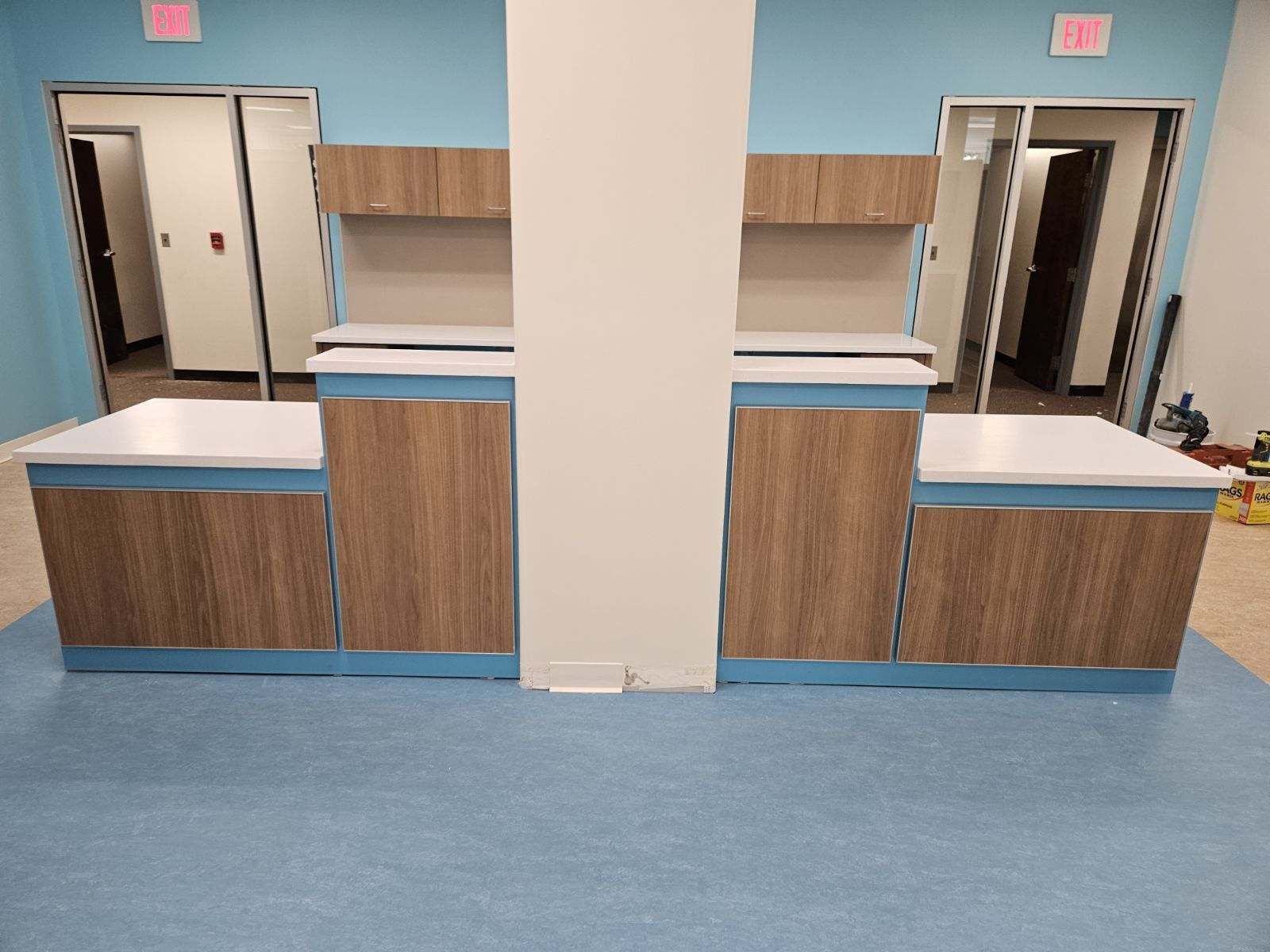 A kitchen with wooden cabinets and a blue floor.
