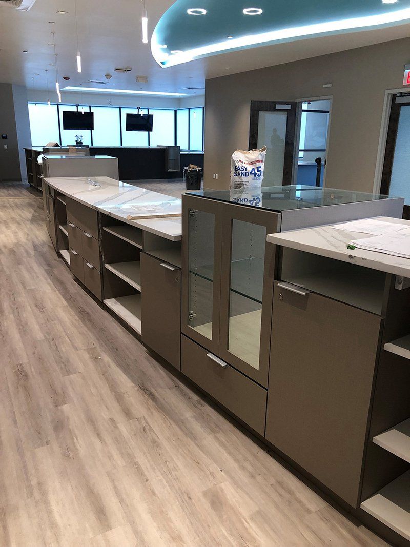 A long room with a lot of cabinets and shelves.