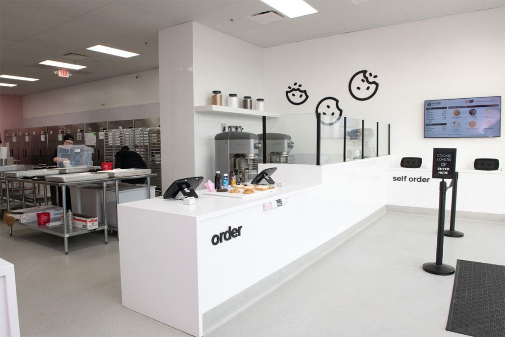 There is a counter in the middle of the room that says order on it.