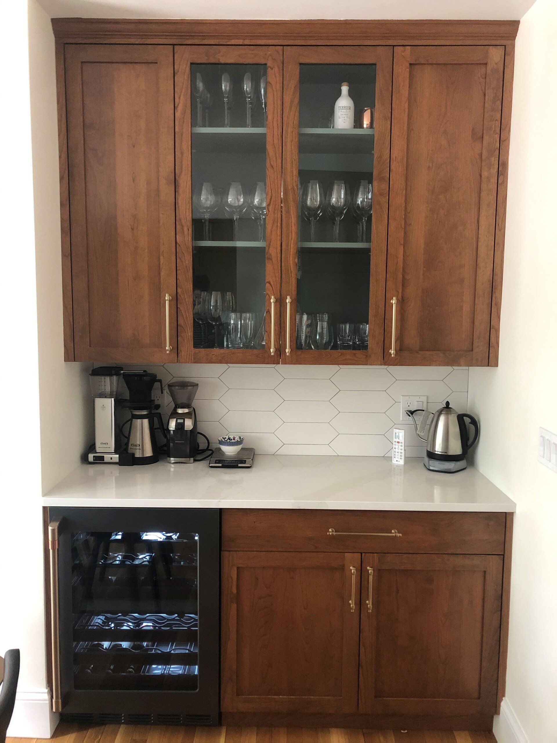 A kitchen with wooden cabinets and a wine cooler