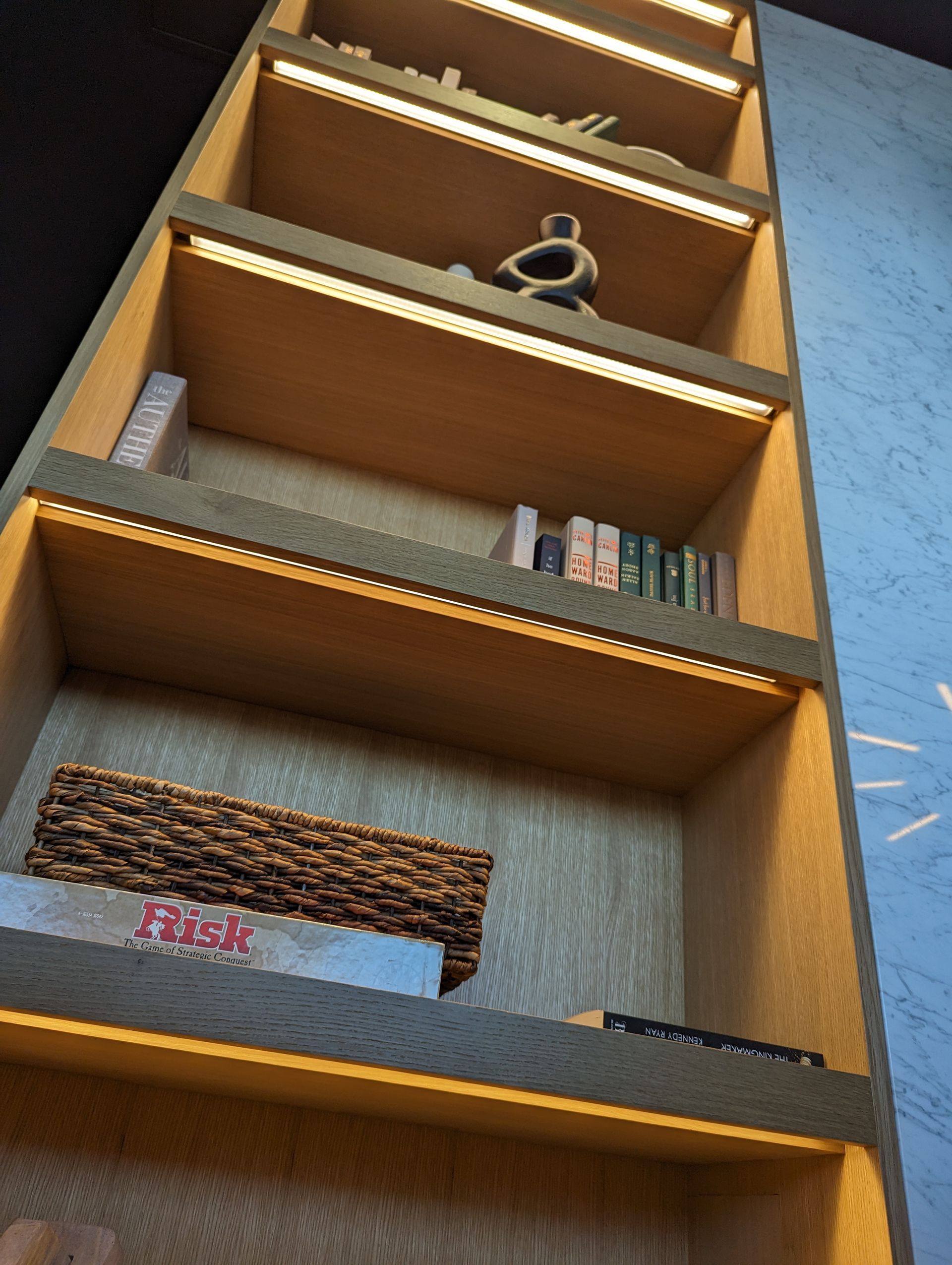 A bookshelf with a few books on it including a book called greek