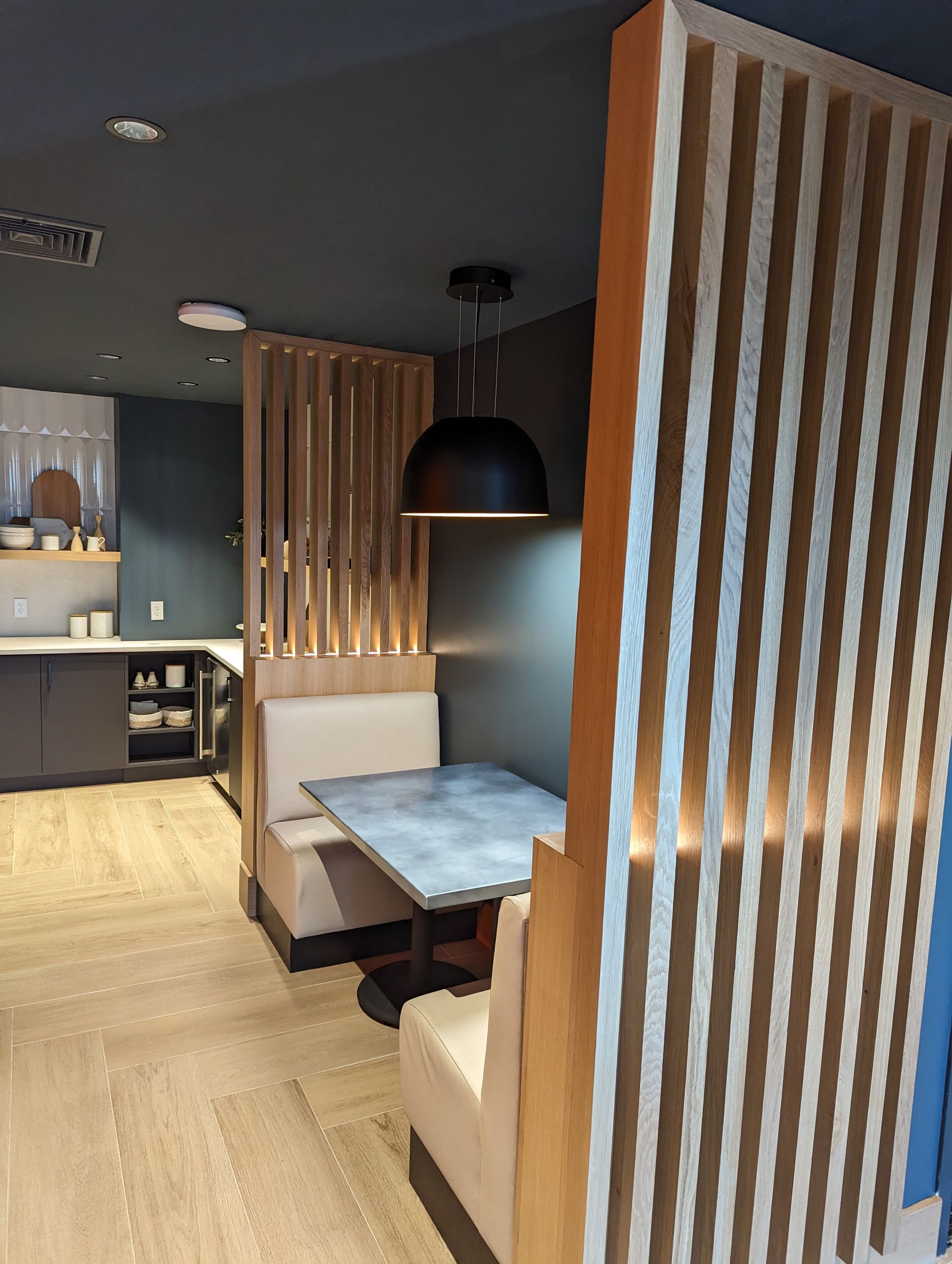A restaurant with a striped wall and a table