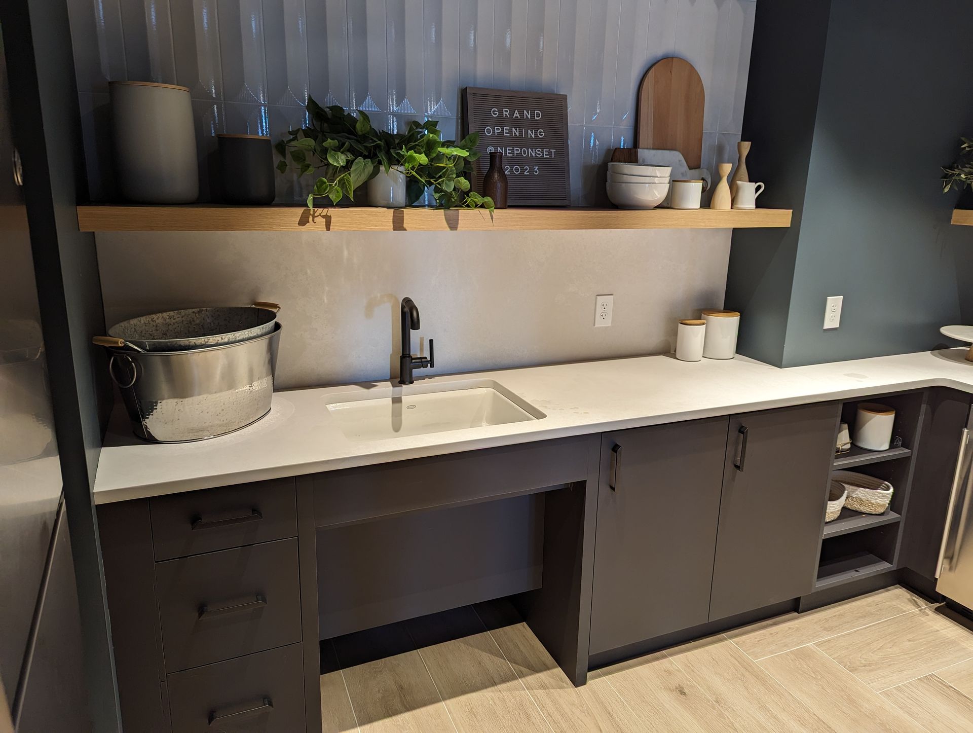 A kitchen with a sink and a sign on the wall