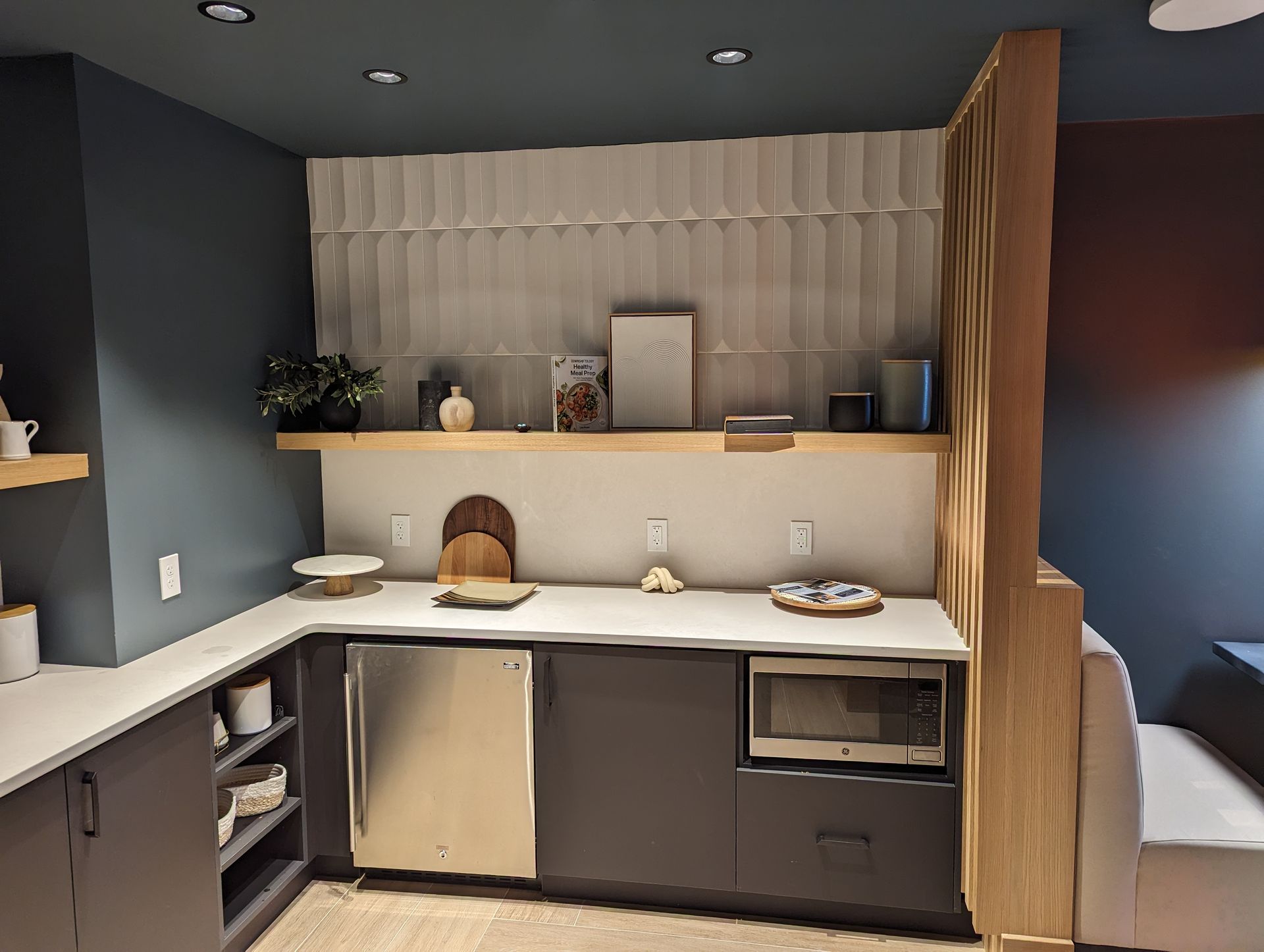A kitchen with a stainless steel dishwasher and a microwave