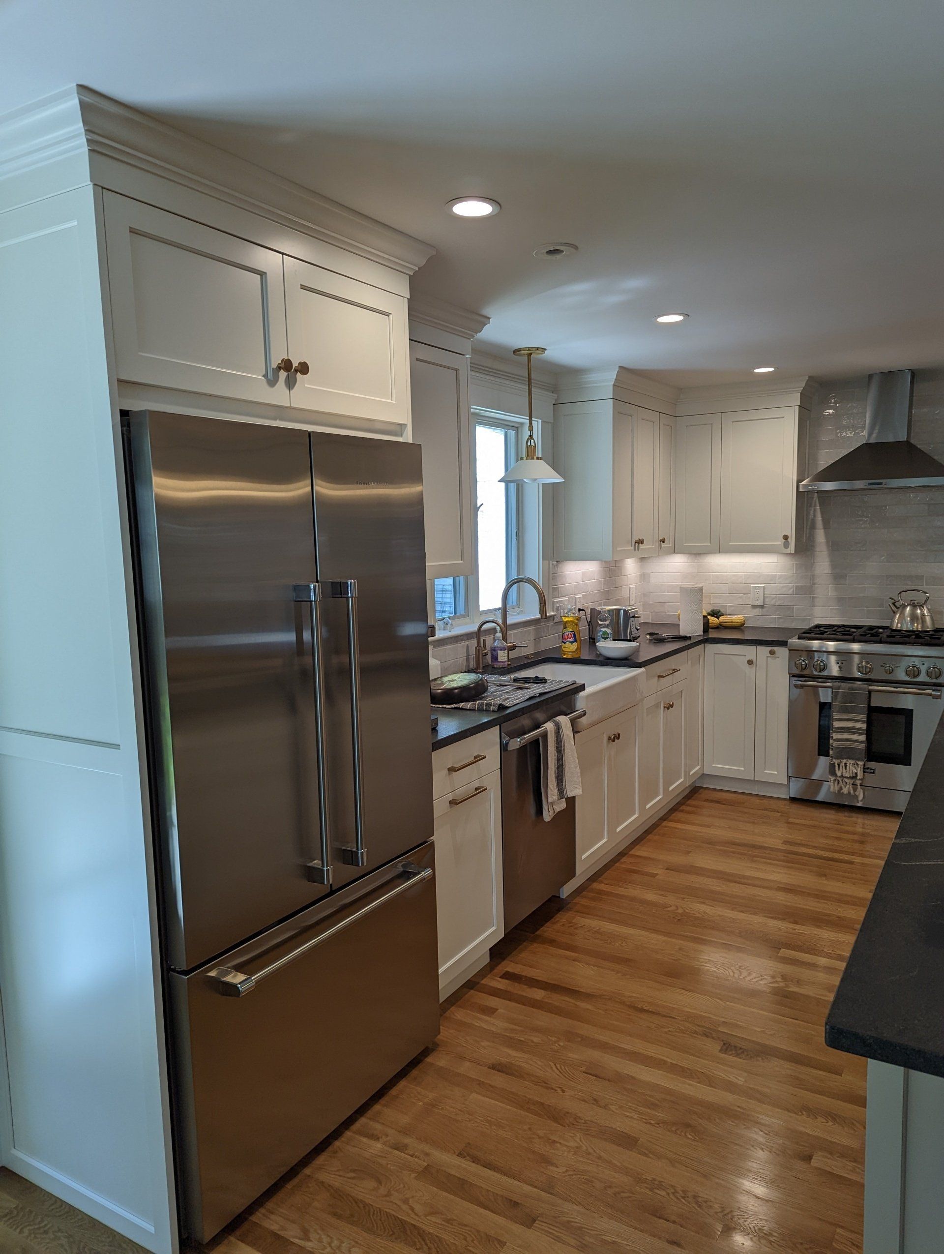 A kitchen with stainless steel appliances and white cabinets