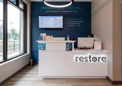A white counter with the word restore on it in a room.