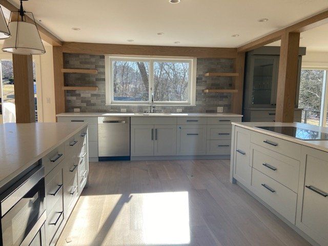 A kitchen with white cabinets and stainless steel appliances