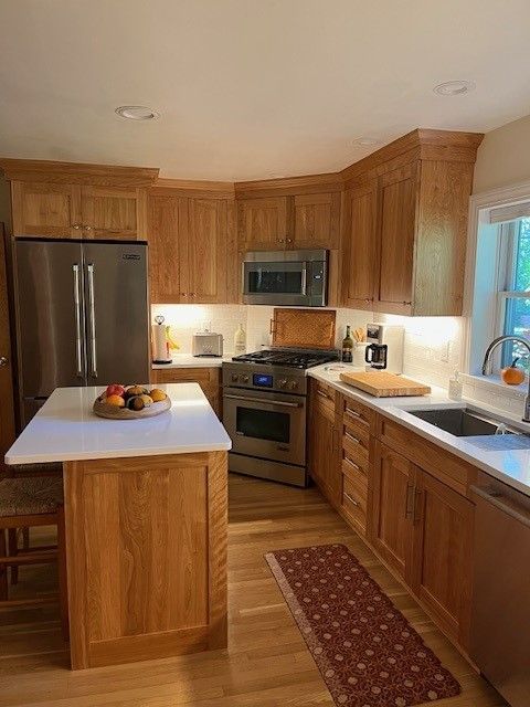 A kitchen with wooden cabinets and stainless steel appliances.