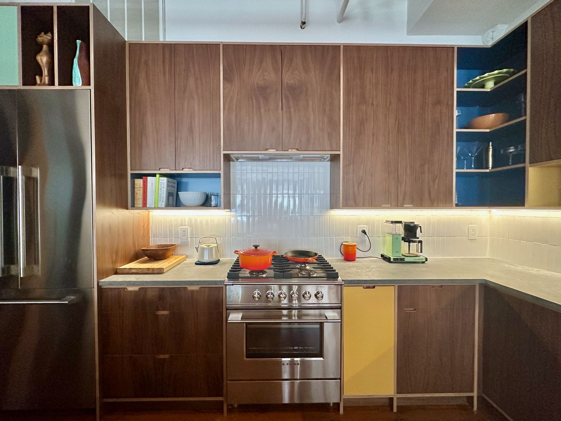 A kitchen with stainless steel appliances and wooden cabinets