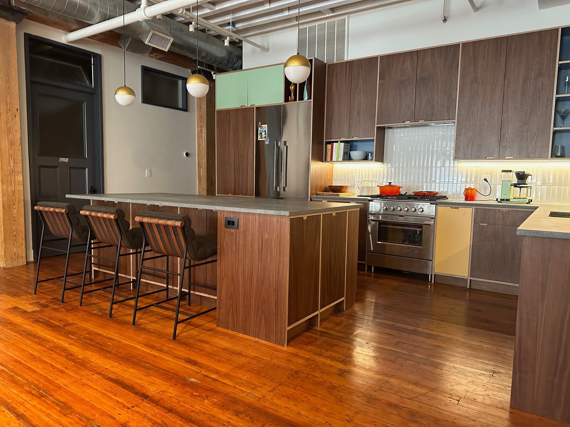 A kitchen with a large island and stools