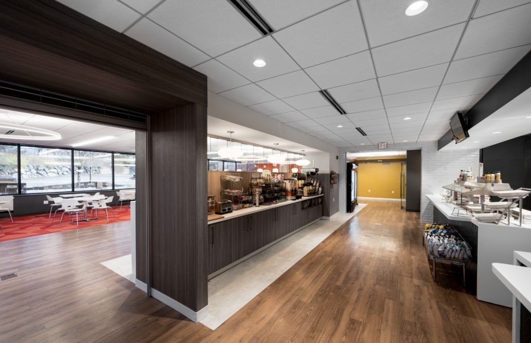 A long hallway with wooden floors and a buffet.
