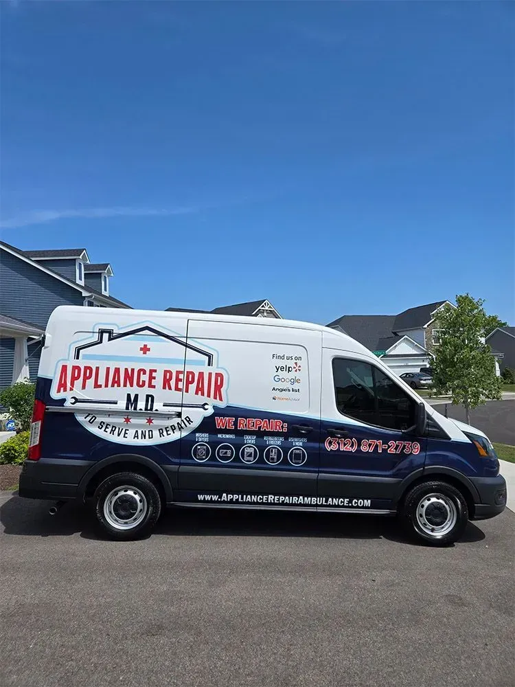 White appliance repair van with blue details parked in front of houses under a blue sky.