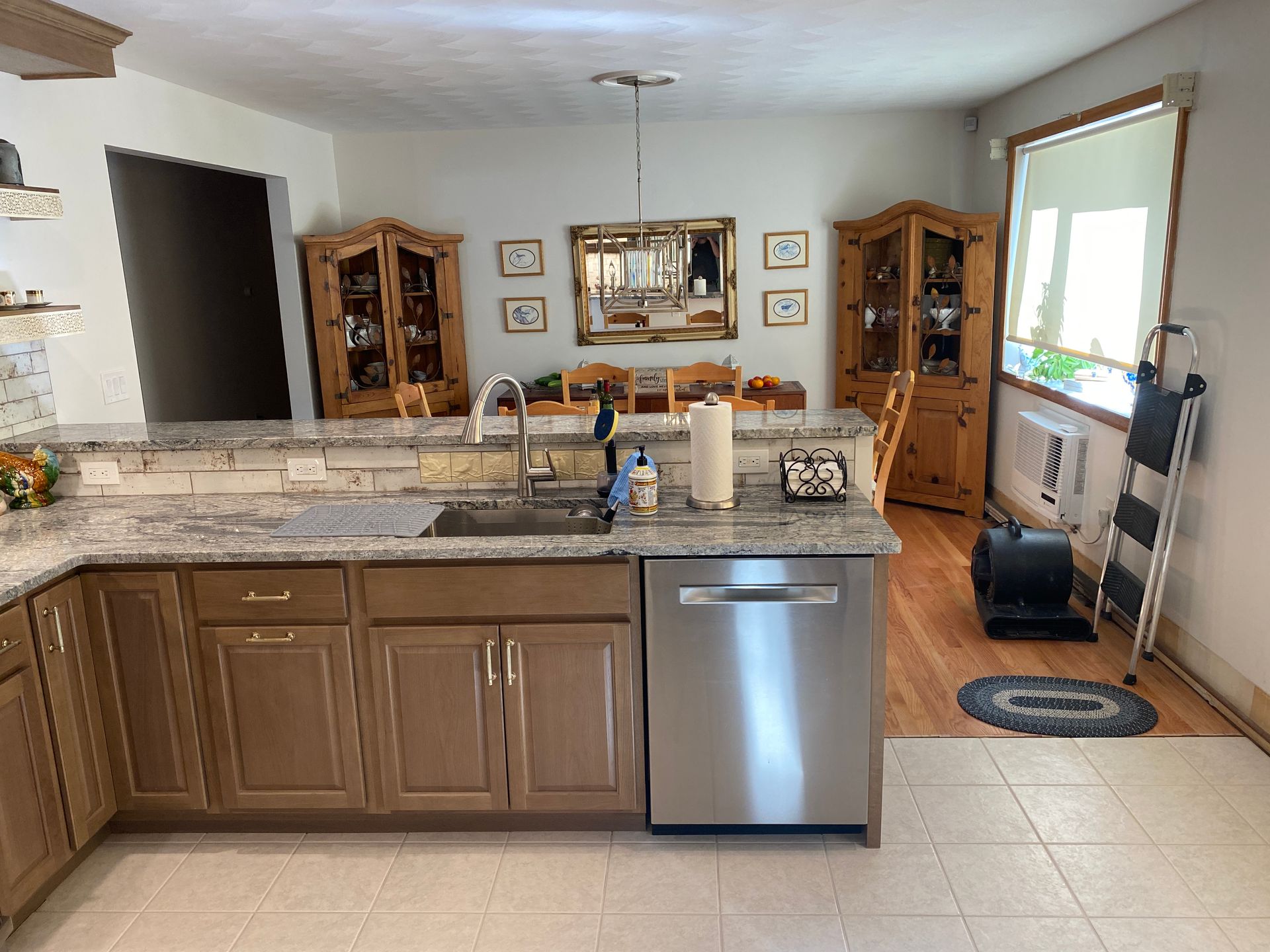 A kitchen with stainless steel appliances and wooden cabinets