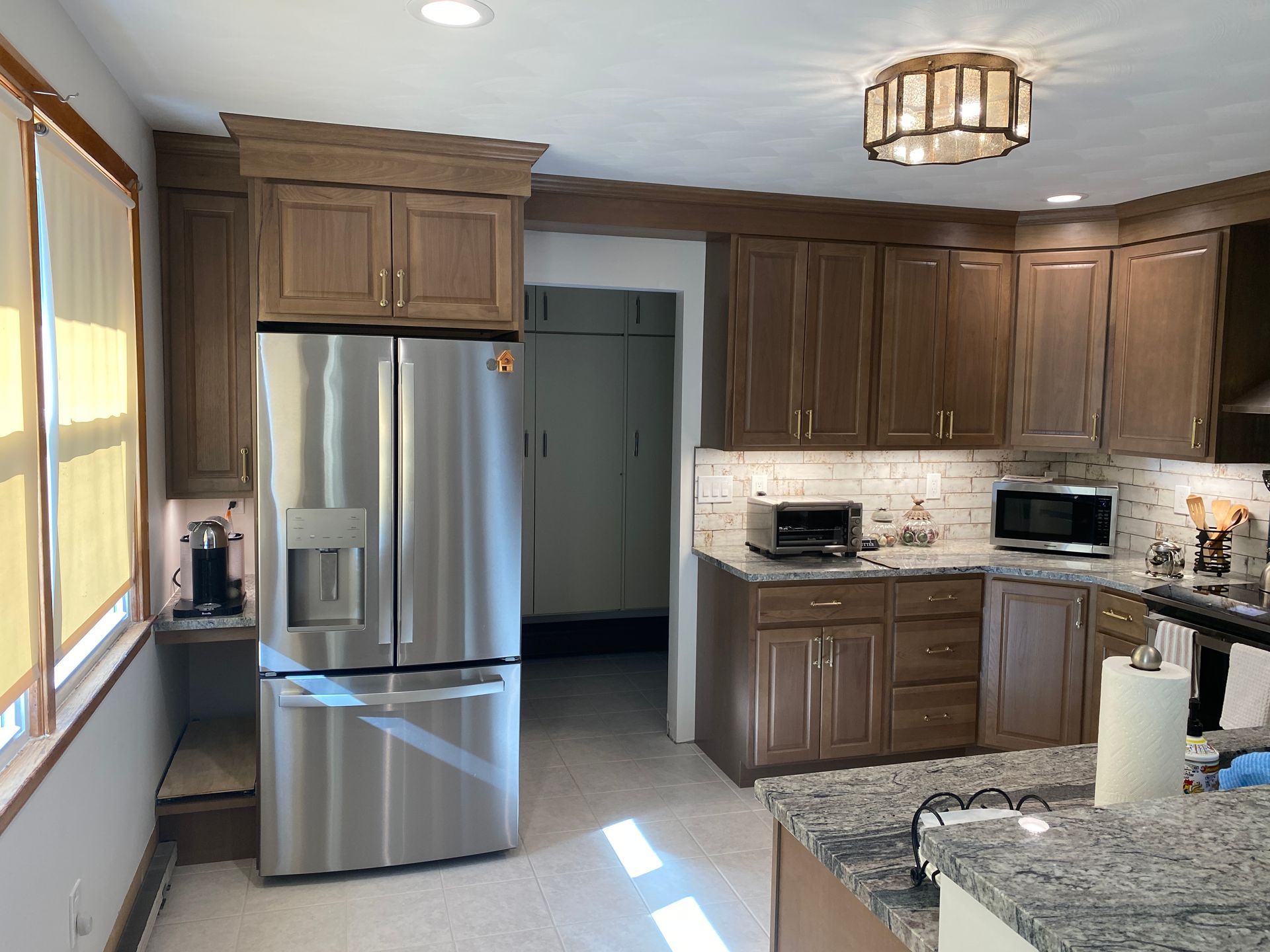 A kitchen with stainless steel appliances and wooden cabinets