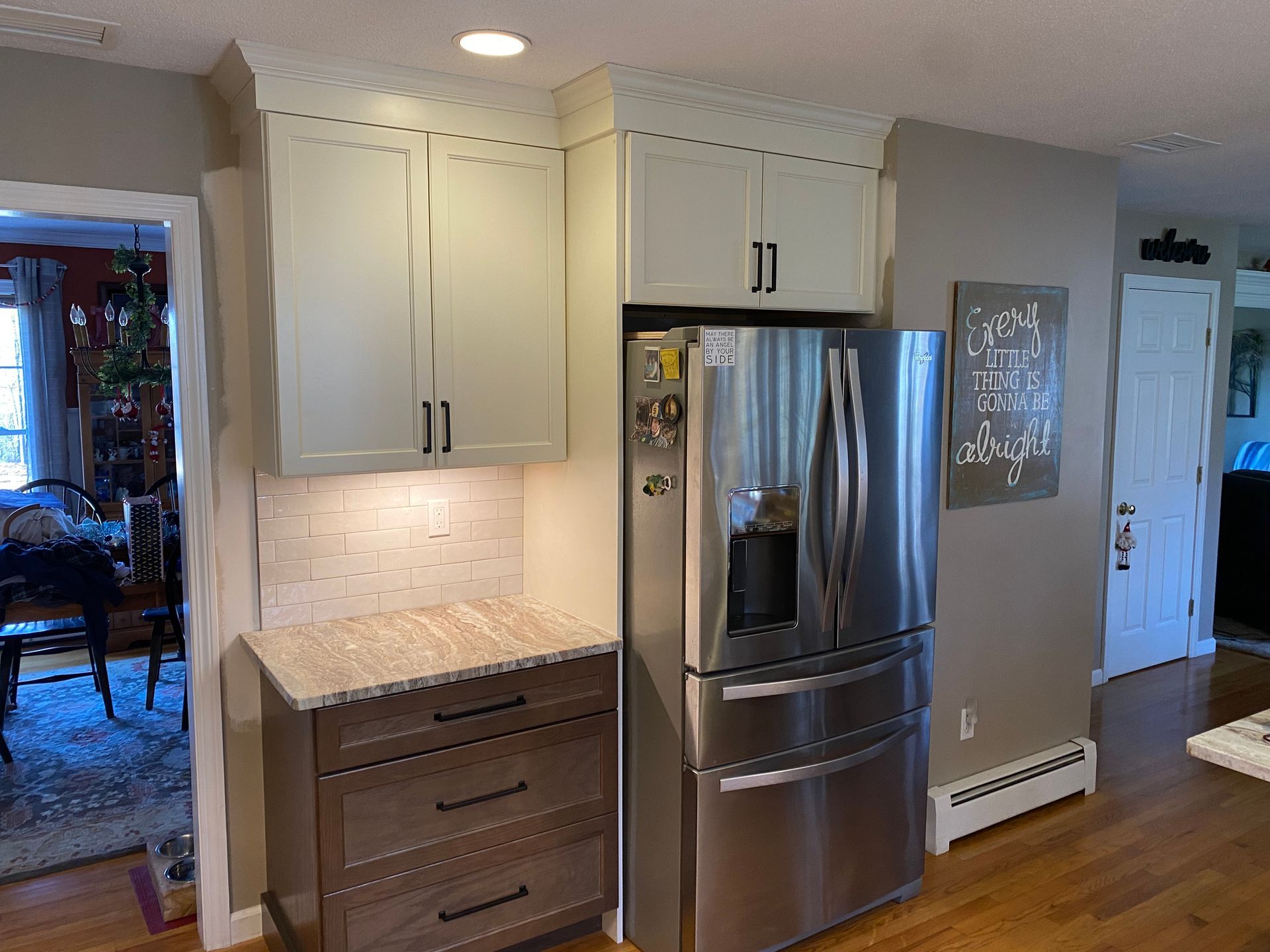 A kitchen with stainless steel appliances and white cabinets.