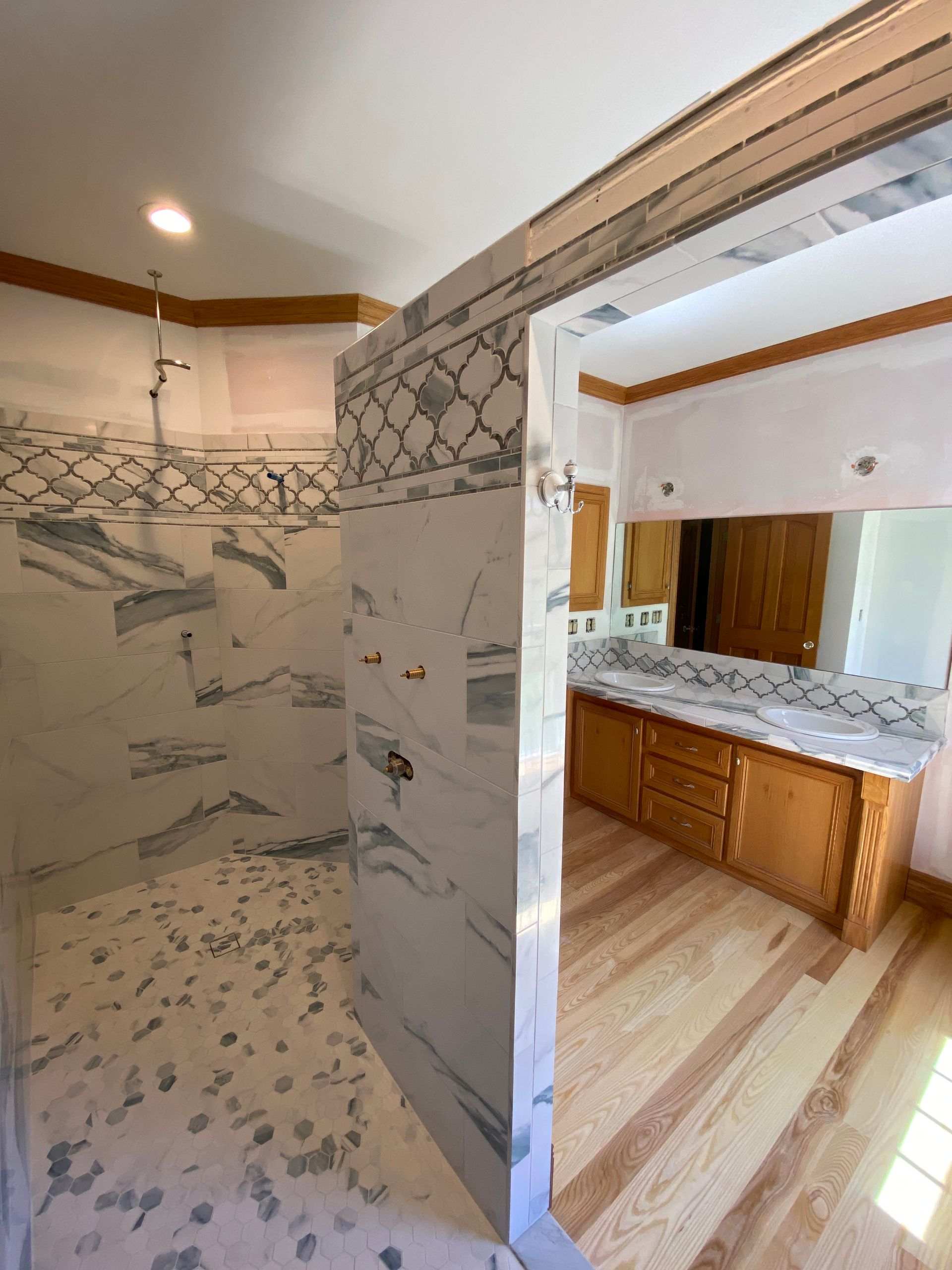 A bathroom with a walk in shower and a sink.