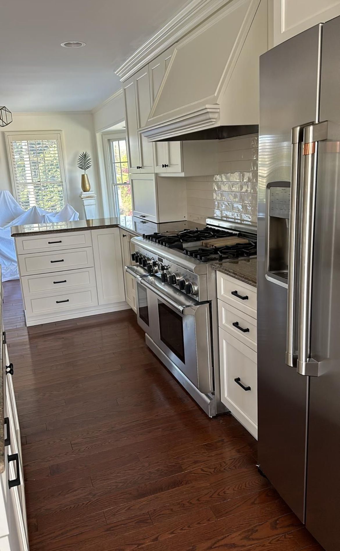 A kitchen with stainless steel appliances and white cabinets