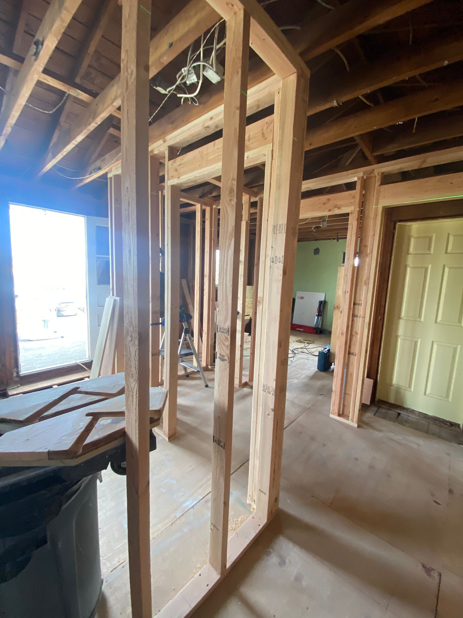 A room under construction with a lot of wooden beams.