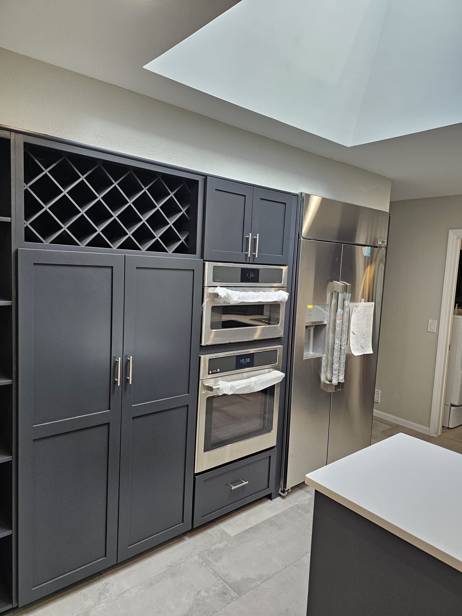 A kitchen with stainless steel appliances and black cabinets